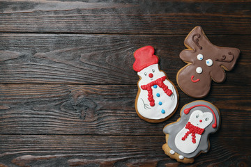 Christmas cookies on a wooden background.Gingerbread Snowman, deer, penguin