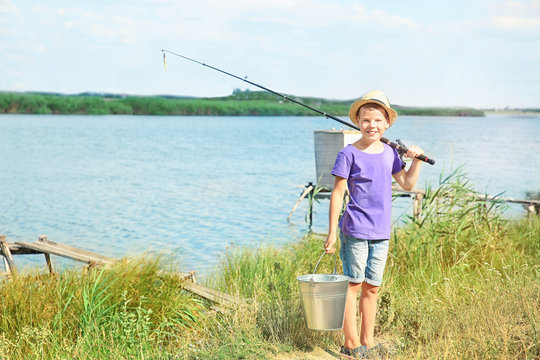 Cute boy going fishing on summer day
