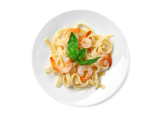 Plate of tasty pasta with shrimps on white background, top view