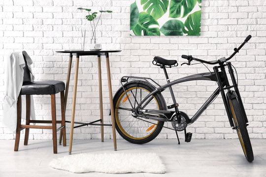 Modern room interior with small table and bicycle