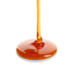 Sweet honey pouring on white background
