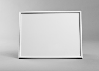 White horizontal frame for paintings or photographs on gray background.