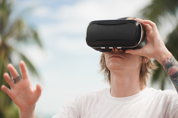 Young man using virtual reality glasses