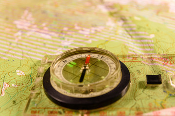 Fototapeta na wymiar Magnetic compass lying on topographical map