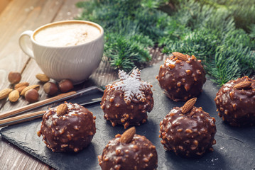 Homemade Christmas or New Year holiday chocolate brownies with nuts on wooden background. Concept of festive desserts