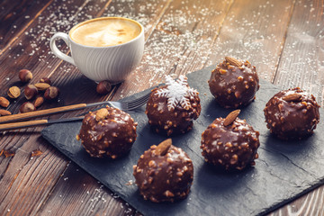 Homemade Christmas or New Year holiday chocolate brownies with nuts on wooden background. Concept of festive desserts
