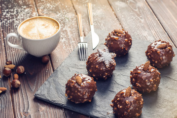 Homemade Christmas or New Year holiday chocolate brownies with nuts on wooden background. Concept of festive desserts
