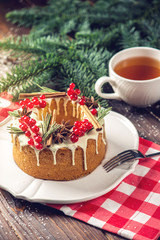Homemade Christmas or New Year holiday berry cake decorated currants and rosemary. Concept of festive desserts