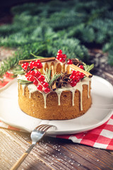 Homemade Christmas or New Year holiday berry cake decorated currants and rosemary. Concept of festive desserts