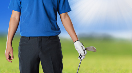 Golf player holding a golf club in golf course
