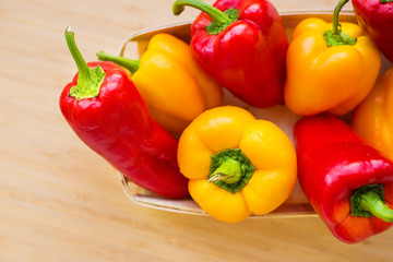 bright yellow and red peppers closeup on the table.