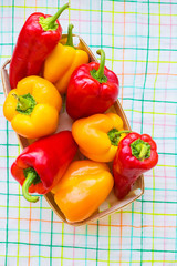 yellow and red peppers closeup on colorful napkin.
