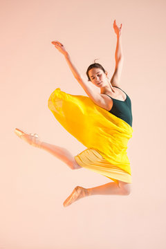 Young and incredibly beautiful ballerina is dancing at studio