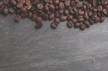 Coffee beans on stone background. Top view with copy space for your text