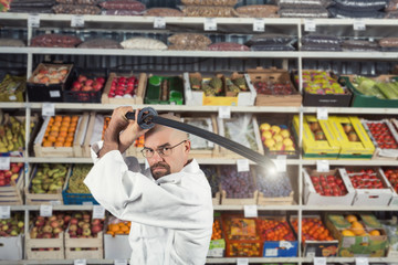 A man against the background with racks with fruits and vegetables dressed in Japanese kimono and hakama holding katana. Fruitarianism concept