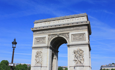 Triumphal Arch (Arc de Triomphe) on Champs Elysees Street and Place Charles de Gaulle Square in Paris, France. Close Up of Famous Tourist Attraction, Travel Landmark of Europe on Sunny Summer Day.