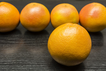 Grapefruit on a wooden dark table.