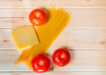 Raw spaghetti pasta with fresh tomatoes and parmesan cheese