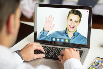 Fototapeta na wymiar businessman using laptop to video chat