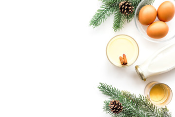 Ingredients for eggnog. Eggs, milk, cinnamon, whiskey on white background top view copyspace