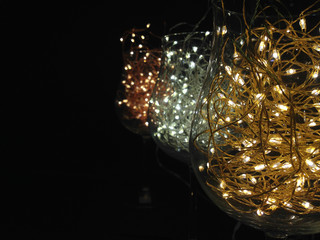 wine glasses or champagne, used to make the toast for the new year, party, Christmas, anniversary, filled with small LED lights, sparkling, gold, silver and bronze, December, Italy