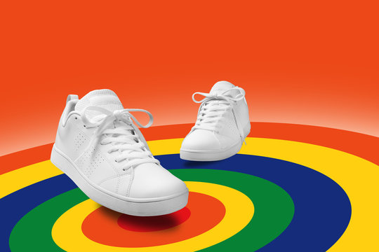 Pair of White sneaker composition like dancing on color full spin cicle  background with clipping path