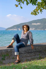 Naklejka na ściany i meble mature brunette woman, lake background