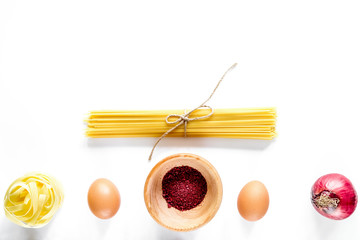 Preparing for cooking italian pasta white background top view co