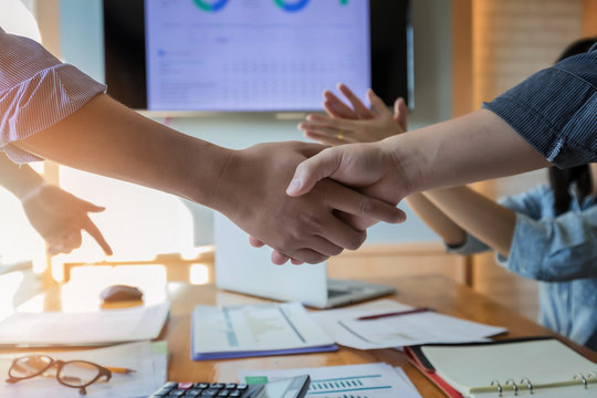 Business people shaking hands finishing up a meeting. Two confident businessman shaking hands during a meeting in the office, success, dealing, greeting and partner concept.