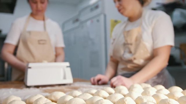 The chef prepares the dough for baking, pieces of raw dough on the Board