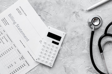 health care billing statement with doctor's stethoscope and pen 