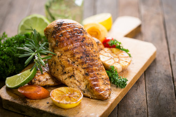 Grilled chicken breast on the cutting board 