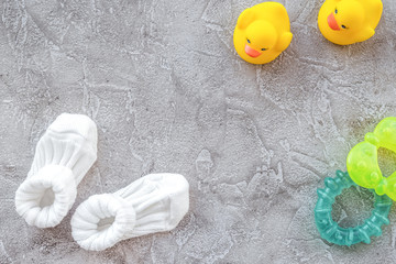 theme for baby shower with shoes and white frame gray background