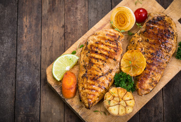 Grilled chicken breast on the cutting board 