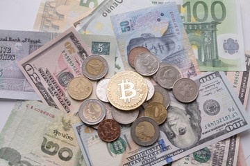 Bitcoin on bills and coins of different countries