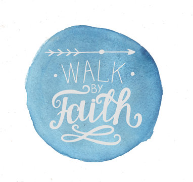 Hand lettering Walk by faith, made on a blue watercolor background