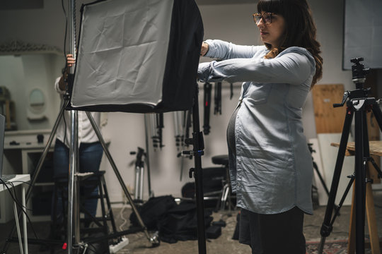 Pregnant woman working in a photographic studio