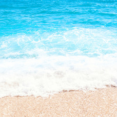 Soft wave of blue ocean on sandy beach Background with place for text. Tropical summer vacation 