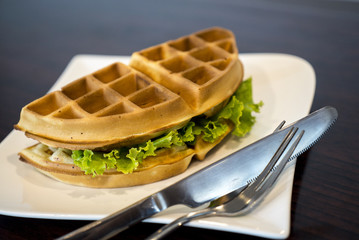 Waffles sandwich with ham cheese.