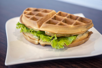 Waffles sandwich with ham cheese.