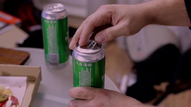 Man hand taking beer can from table and putting it back