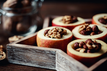 Baked apples with cinnamon on rustic background. Autumn or winter dessert. Closeup photo of a tasty baked apples with christmas decoration