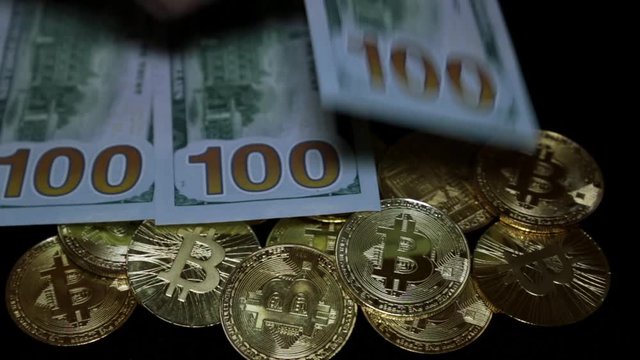 Gold coins bitcoins and US dollars.