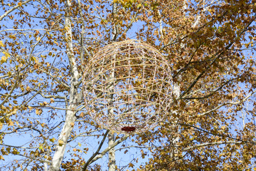 ball out of a garland hanging in the park. Lighting decorative element.