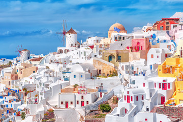Incredible traditional white and colorful Greek architecture with fascinating wind mills on...