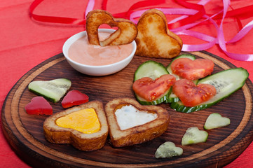 French fries and fresh vegetables chopped in the shape of a heart. Valentine's Day