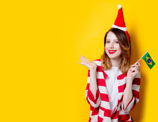 woman in Santa Claus hat with Brasil flag