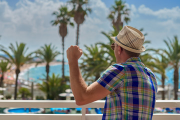 Fototapeta premium Man in sunhat watching at amazing sea view.