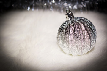 Christmas background. New Year's background. Silver ball on a light background. Selective focus.