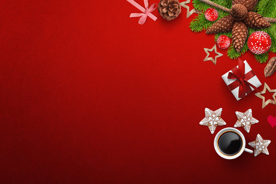 Red background with Christmas decoration on right side with coffee, gift box and cookies, free space for adding text, logo etc...